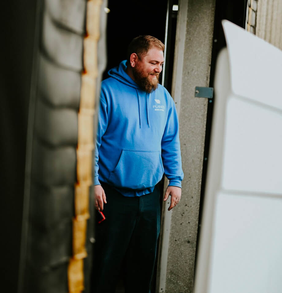 Planes member moving boxes off truck