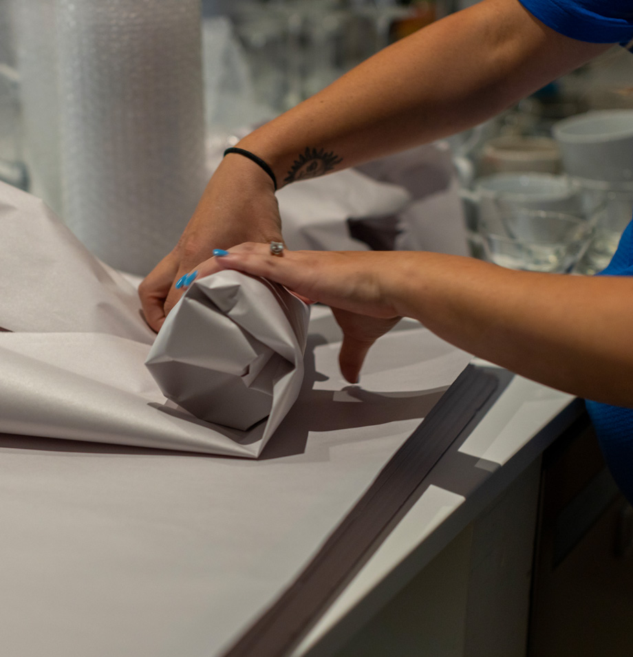 Planes packing glassware in paper wrap