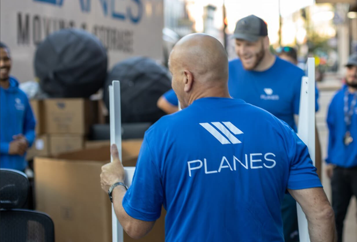 Planes employees moving office furniture