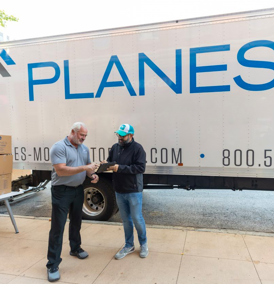 Planes Employees meeting outside of moving truck