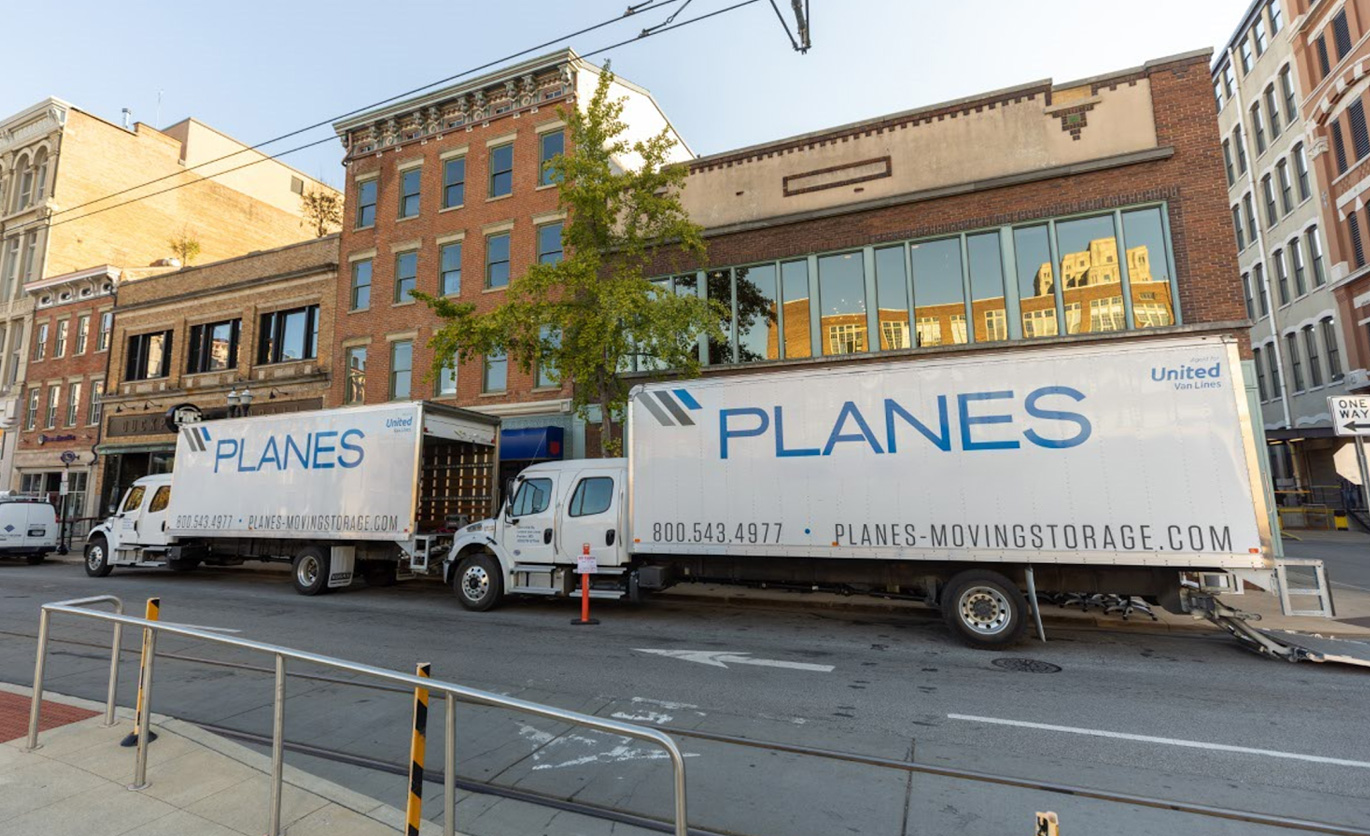 Planes moving truck on street