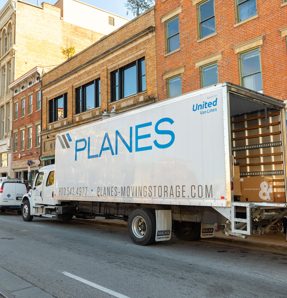 Planes truck parked on street during a white glove installation.