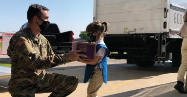 Child giving a soldier a package